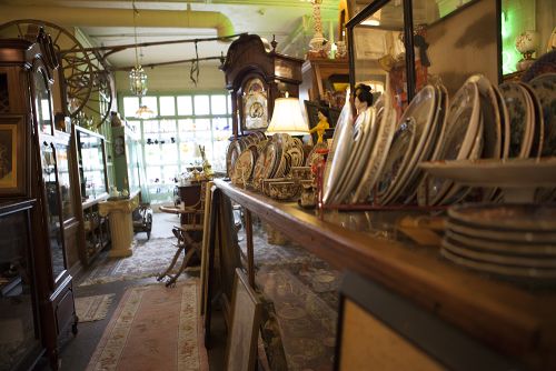 The image is antique plates lined up at Carriage Town antique store.