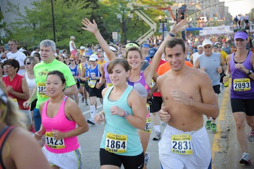 The image is of a group of people running in a marathon. 